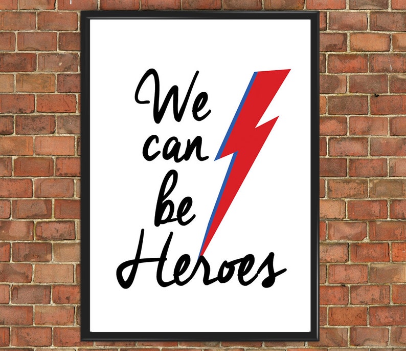 May include: A white framed print with a black and red lightning bolt graphic and the text "We can be Heroes".