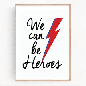 May include: A white framed print with a red and blue lightning bolt and the text "We can be Heroes" in black.