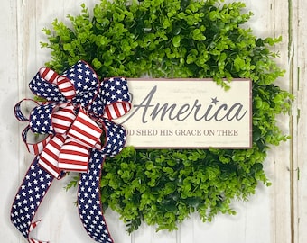 20-22" Diameter Faux Boxwood Wreath on Foam Backing with American Flag Bow and Wooden Sign Insert