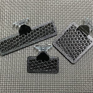 May include: Three black car sunshades with suction cups. Each sunshade has a honeycomb pattern.