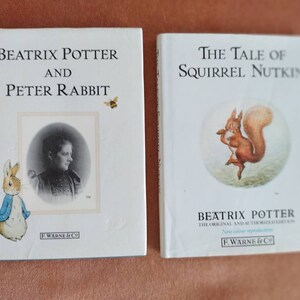 May include: Two vintage Beatrix Potter books, "Beatrix Potter and Peter Rabbit" and "The Tale of Squirrel Nutkin." The books feature illustrations of Peter Rabbit and Squirrel Nutkin, and both have the F. Warne & Co. logo.