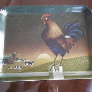 May include: A white serving tray with a green border and a rooster illustration. The rooster is standing on a fence post with a red barn and cows in the background. The tray has the text "R. Lowell Messer" at the bottom.