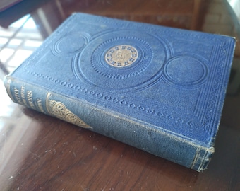 May include: A blue hardcover book with gold lettering and decorative designs. The title of the book is "The Mystery of Edwin Drood".