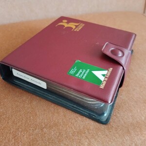 May include: A burgundy leather-bound album with a green sticker that says "Design Council Selection" and "Made in Australia". The album has a label that says "Australian Animals".