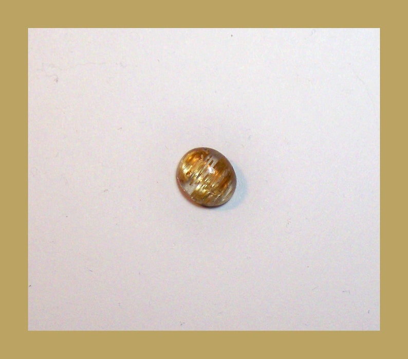 CATSEYE RUTILATED QUARTZ Cabochon \u2013 Unique Rolling Broad Flash Effect \u2013 10 x 8 Millimeter Oval \u2013 Made In Maine