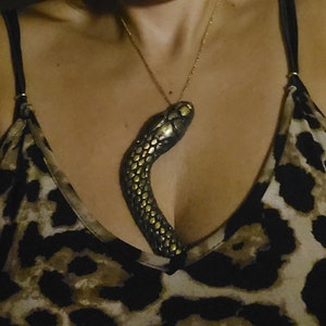 Intriguing shimmery gold and black snake necklace. Don&#39;t wear this if you&#39;re not ready for compliments! Unique & exciting half snake :)