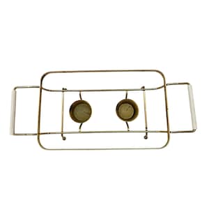 May include: Gold metal candle holder with two white candles. The holder has two handles on either side.