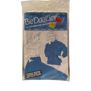 May include: A package of 24 hot-iron-on transfers for Western wear. The package features two designs: a denim jacket and a denim shirt with a skirt. The text on the package reads "Be Dazzler" and "24 Hot-Iron-On Transfers".