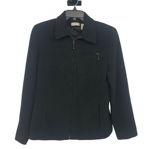 May include: A black zip-up jacket with a collar and a pocket on the left side. The jacket has a label that says "Ann Taylor" on the inside.