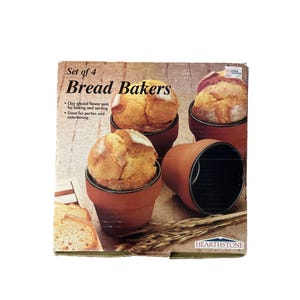 May include: A set of four clay glazed flower pots, each containing a baked loaf of bread. The packaging reads "Set of 4 Bread Bakers" and "Clay glazed flower pots for baking and serving". The pots are brown with a black interior.