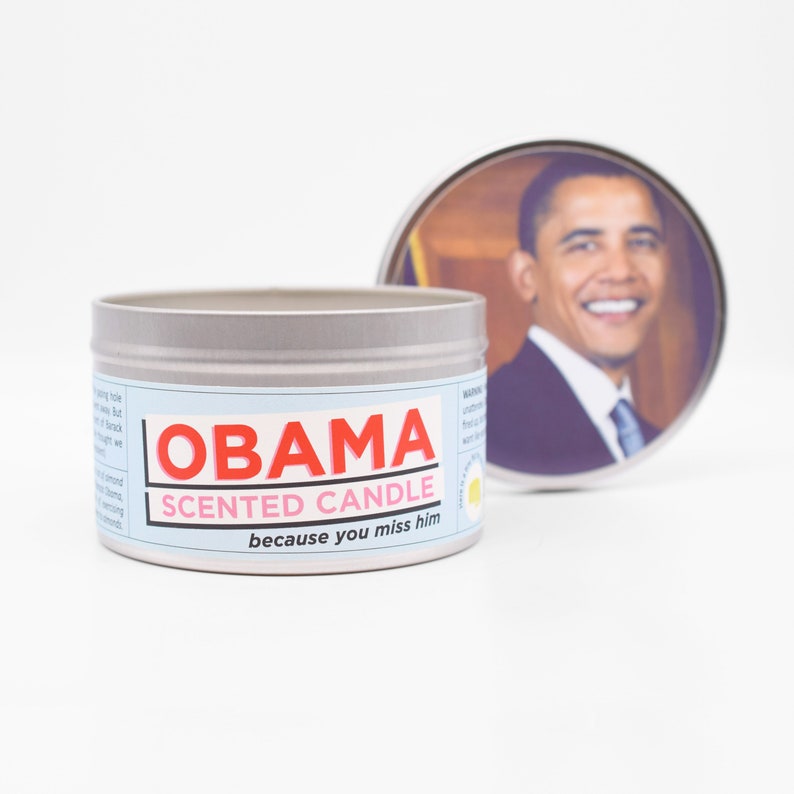 The Obama Scented Candle with the lid propped up behind it so you can admire Barack Obama.