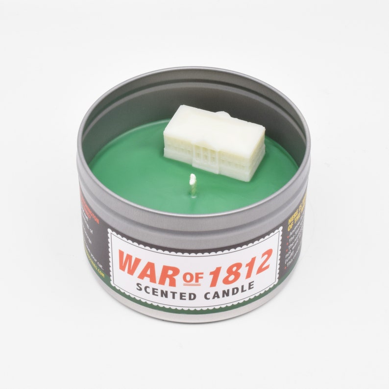 The surface of the candle is green (like grass!), and the tiny wax White House is white (for obvious reasons).