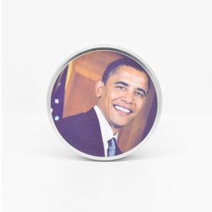 The lid of the Obama Scented Candle features a handsome photo of Barack Obama for you to admire.