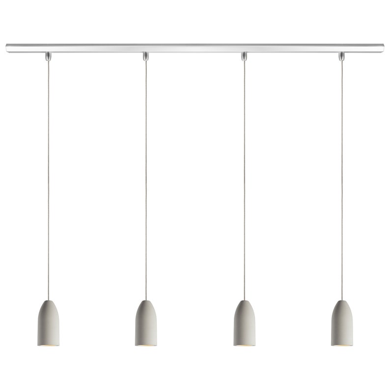 May include: A set of four pendant lights with white ceramic shades hanging from a silver track.