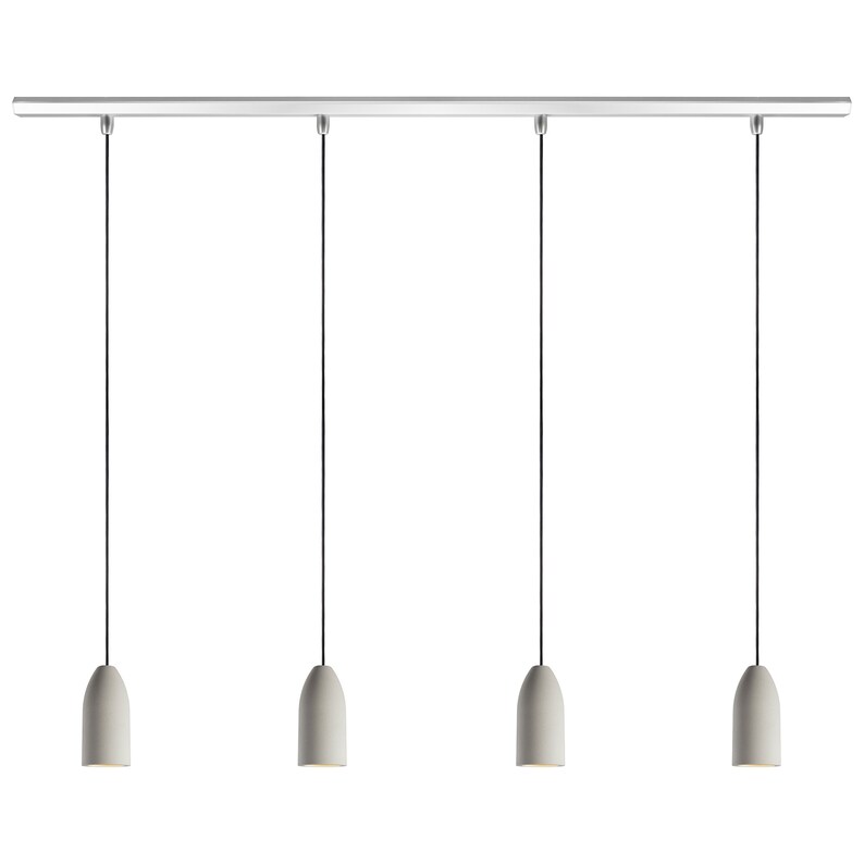 May include: A set of four white pendant lights with a silver track. The lights are suspended from the track by black cords.