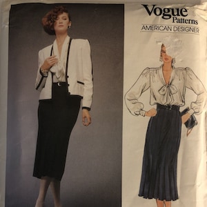 May include: Vogue Patterns American Designer sewing pattern #1483 by Adele Simpson. The pattern features two looks: a white jacket with a black skirt and a white blouse with a black skirt.