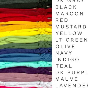 May include: A collection of 18 fabric headbands in various colours, including white, cream, tan, light grey, dark grey, black, maroon, red, mustard, yellow, light green, olive, navy, indigo, teal, dark purple, mauve, lavender, hot pink, coral, pink, and pale pink.