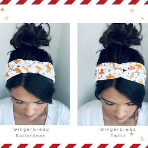 May include: Two women are wearing white headbands with a gingerbread man pattern. The headband on the left is tied in a sailor knot, while the headband on the right is tied in a twist. Both headbands have blue stars on them.