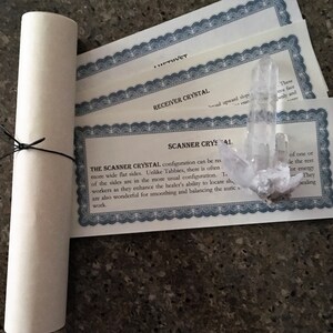 May include: A clear quartz crystal with a certificate that reads "The Scanner Crystal configuration can be more wide flat sides. Unlike Tabbies, there is often of the sides are in the more usual configuration. Workers as they enhance the healer's ability to locate sh are also wonderful for smoothing and balancing the auric work."