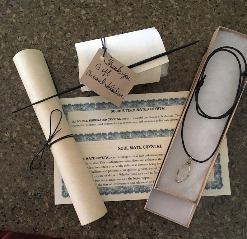 May include: A double terminated crystal necklace on a black cord in a small box. The box has a certificate that reads "Double Terminated Crystal" and "Soul Mate Crystal". The certificate explains that the double terminated crystal is a natural termination at both ends. The Soul Mate Crystal is recognized as two individual crystals side by side. This configuration symbolizes and enhances the idea of a Soul Mate, generally defined as another being loving and promoting spiritual growth.