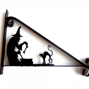 May include: Black metal wall bracket shaped like a triangle with a witch and a black cat silhouette. The witch is holding a cauldron and a broom.