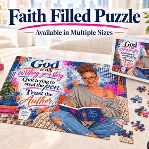 May include: A rectangular jigsaw puzzle featuring a person writing in a book with the text: God is still writing your story. Quit trying to steal the pen. Trust the Author. The puzzle is displayed with a matching tin box and scattered pieces.