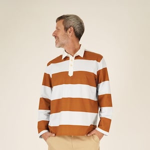 May include: A person wearing a brown and white striped long-sleeve polo shirt, khaki pants, and white sneakers with burgundy stripes. The shirt has a white collar and a three-button placket. The sneakers have a brown sole.
