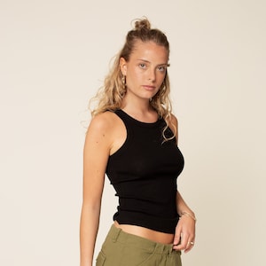 May include: A black ribbed tank top with a scoop neck and a relaxed fit.