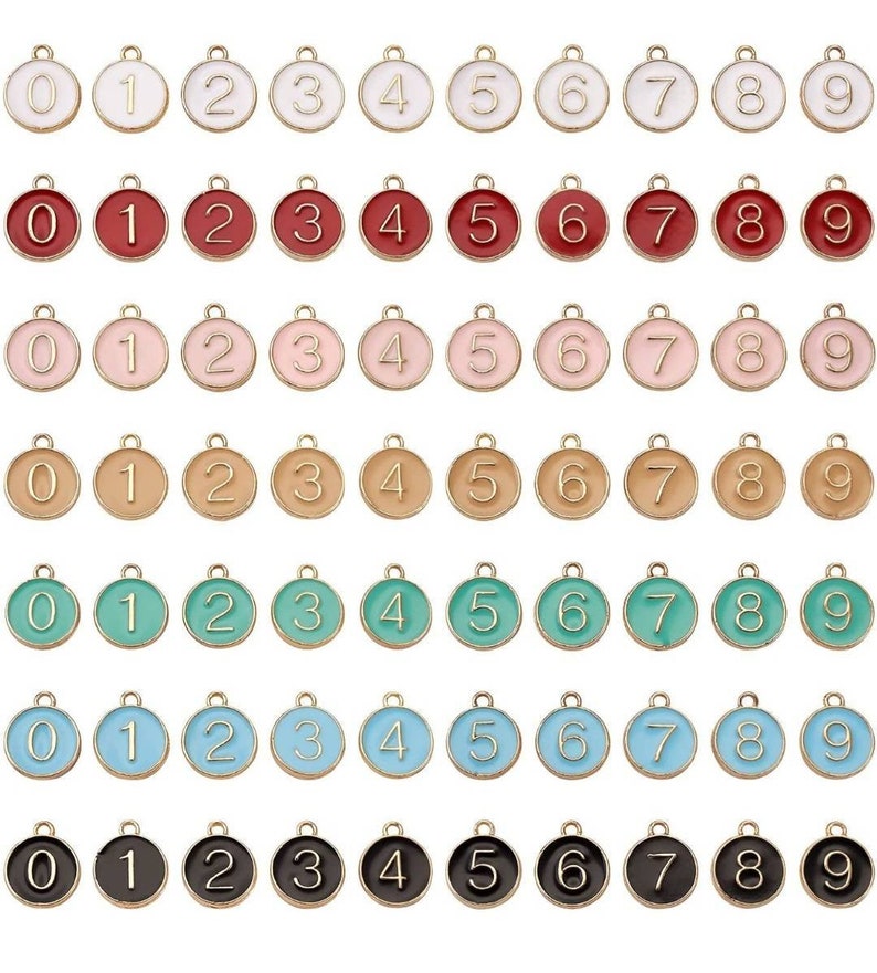May include: Set of ten gold-tone metal charms with enamel numbers 0-9. The charms are round and have a loop at the top for attaching to a necklace, bracelet, or other jewelry.