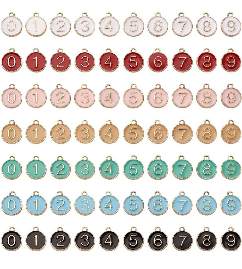 May include: Set of ten gold-tone metal charms with enamel numbers 0-9. The charms are round and have a loop at the top for attaching to a necklace, bracelet, or other jewelry.