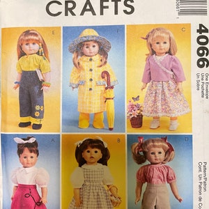 May include: McCall's Crafts 4066 sewing pattern envelope featuring illustrations of six dolls wearing various outfits, including a yellow top with blue pants, a yellow raincoat with a hat, a purple wrap top with a floral skirt, and other ensembles.