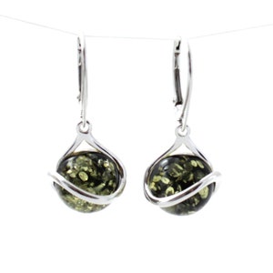 May include: A pair of silver dangle earrings with green amber stones. The stones are round and have a swirl design around them.