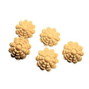 May include: Six light tan, flower-shaped decorative wooden embellishments. Each flower has a central circular element surrounded by multiple petals. The embellishments are arranged against a white background.