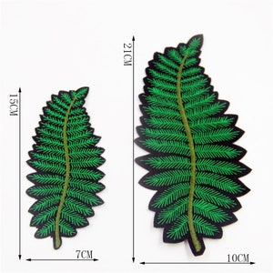 May include: Two green embroidered fern leaf patches. The larger patch is 10 inches wide and 21 inches long. The smaller patch is 7 inches wide and 15 inches long.