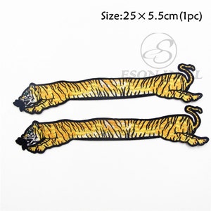 May include: Two embroidered iron-on patches of a yellow and black tiger, each measuring 25 inches by 5.5 inches. Size: 25 x 5.5cm (1pc)