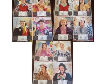 May include: A collection of vintage calendar prints featuring women in various outfits and hairstyles. Each print has a calendar at the bottom. The images showcase a range of colors and styles, with a focus on fashion and portraiture.