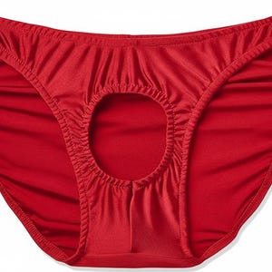 May include: Red underwear with a keyhole design. The briefs are made of a smooth, shiny fabric. The waist and leg openings are finished with a narrow hem.