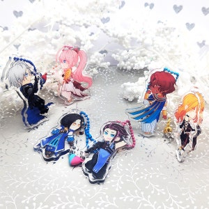 May include: Five colourful anime character keychains with chains attached. The characters are drawn in a chibi style and are wearing various outfits. The keychains are made of clear acrylic and have a glossy finish.