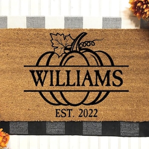 May include: A brown coir doormat with a black pumpkin design and the text "WILLIAMS EST. 2022".