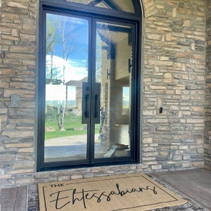 May include: A brown doormat with the text "THE Thessalonians" in black cursive lettering.