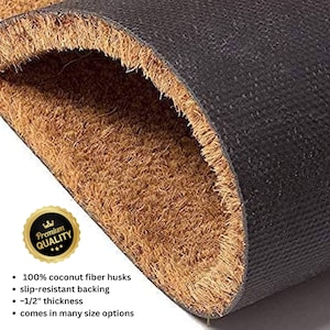 May include: A close-up of a brown coir doormat with a black rubber backing. The doormat is made of 100% coconut fiber husks and is slip-resistant. It is approximately 1/2 inch thick and comes in many sizes.
