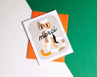 A risograph thank you greeting card of a spotted cat with a French word