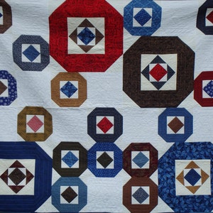 modern queen size red, blue and brown quilt image 1