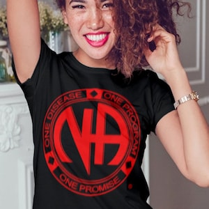 May include: Black t-shirt with a red circle logo that says "NA" in the center and "One Disease, One Program, One Promise" around the outside.