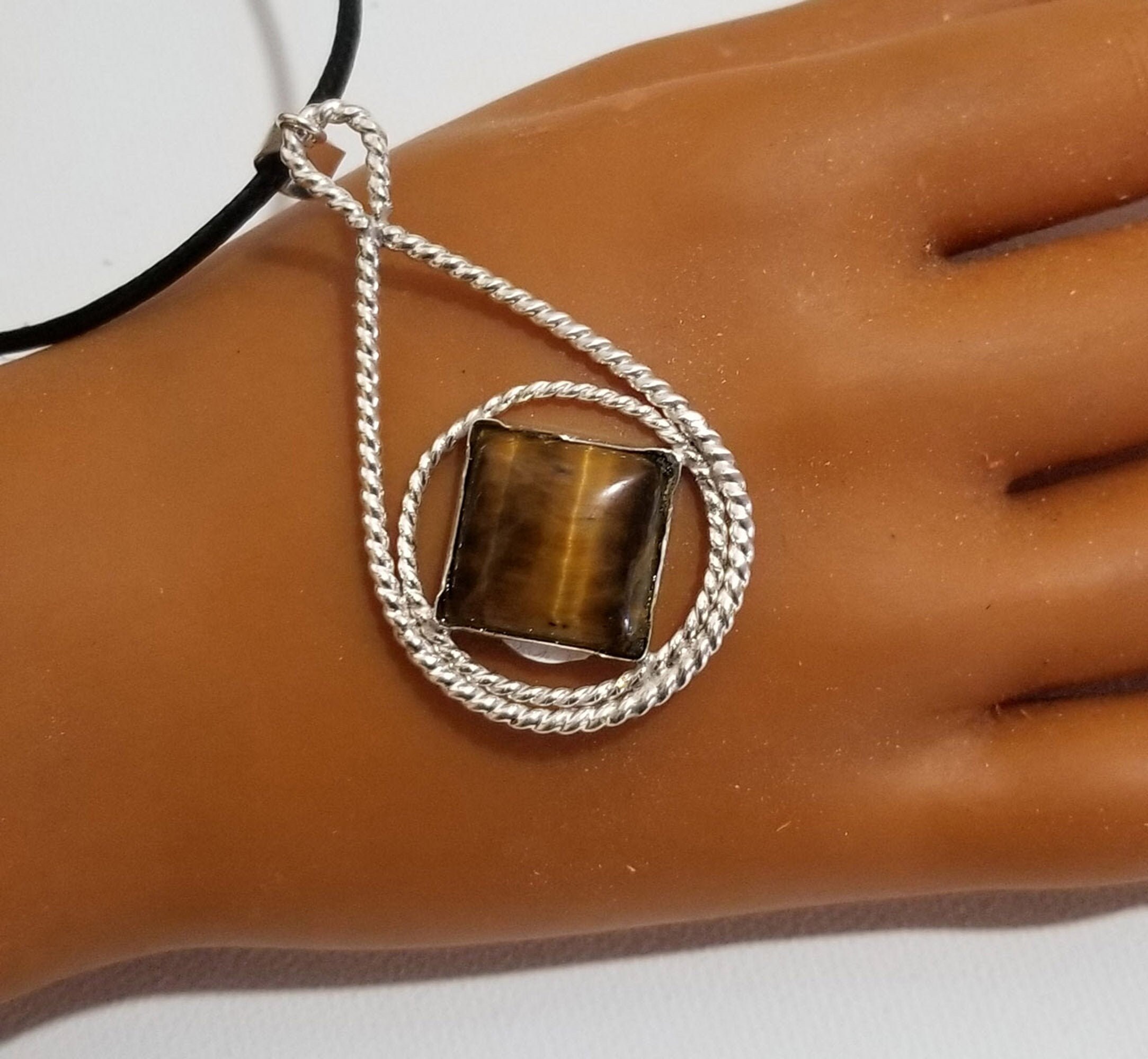 Az0168- Sterling Silver, Tigers Eye Symbol Pendant . Twisted