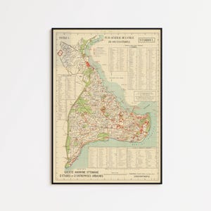 May include: Framed vintage map of Istanbul, Turkey, with text in French. The map features detailed street layouts, green areas, and a blue body of water. The map is in a black frame.