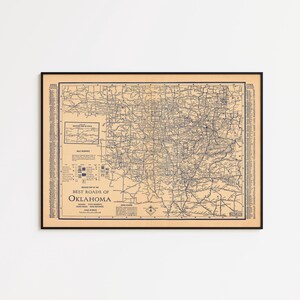 May include: Framed vintage map of Oklahoma, featuring a detailed road network in blue against a tan background. The map includes the text "Best Roads of Oklahoma" and other informational text. The map is enclosed in a black frame.