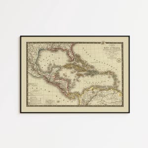 May include: A framed antique-style map of the Caribbean and Gulf of Mexico, titled 'CARTE DES ILES ANTILLES ET DES CÔTES OCCIDENTALES'. The map features beige parchment-toned paper with black ink details, coastlines, and geographical labels.