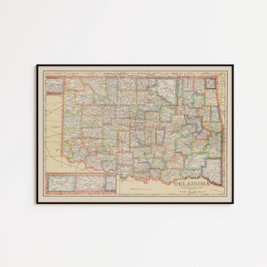 May include: A framed vintage map of Oklahoma featuring a cream-colored background with detailed county lines, roads, and geographical markings in muted tones of red, green, and blue, with the word OKLAHOMA printed in the lower right corner.
