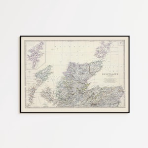 May include: Framed vintage map of Scotland, featuring detailed geographical information. The map is in a black frame and displays a cream-colored background with various shades of green, purple, and brown. The word "Scotland" is visible on the map.